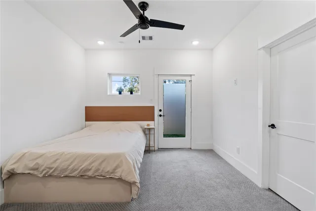 a spacious bedroom with a bed and a chandelier