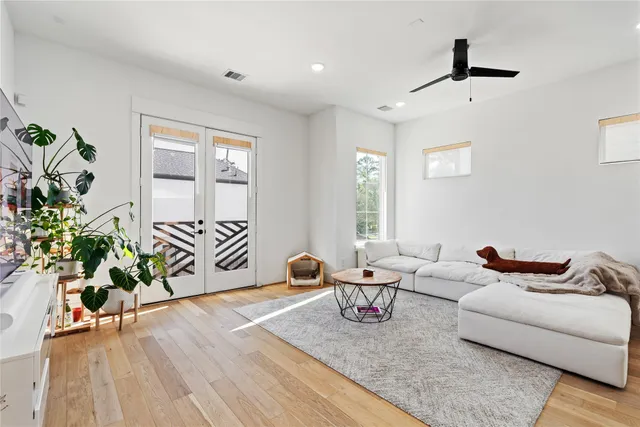 a living room with furniture and a potted plant