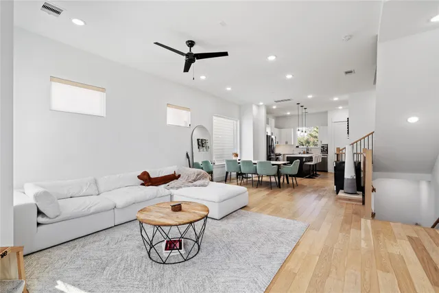 a living room with furniture and kitchen view