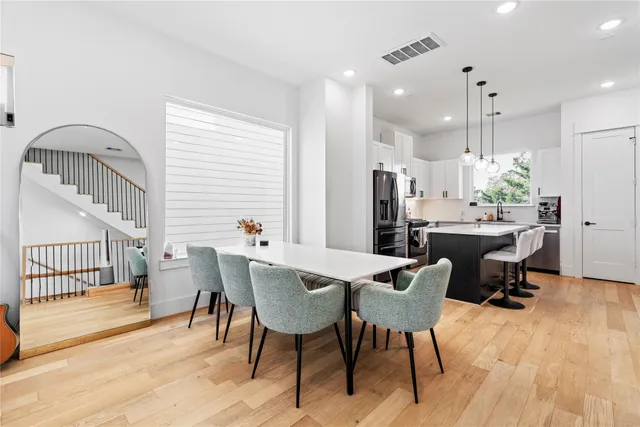 a view of a dining room with furniture and wooden floor