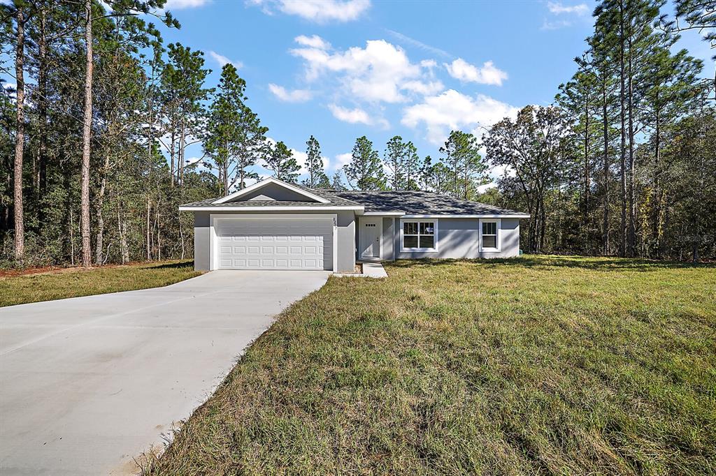 81 Pecan Course Loop Ocala, FL 34472 - Photo 1 of 1 a front view of a house with a garden and yard