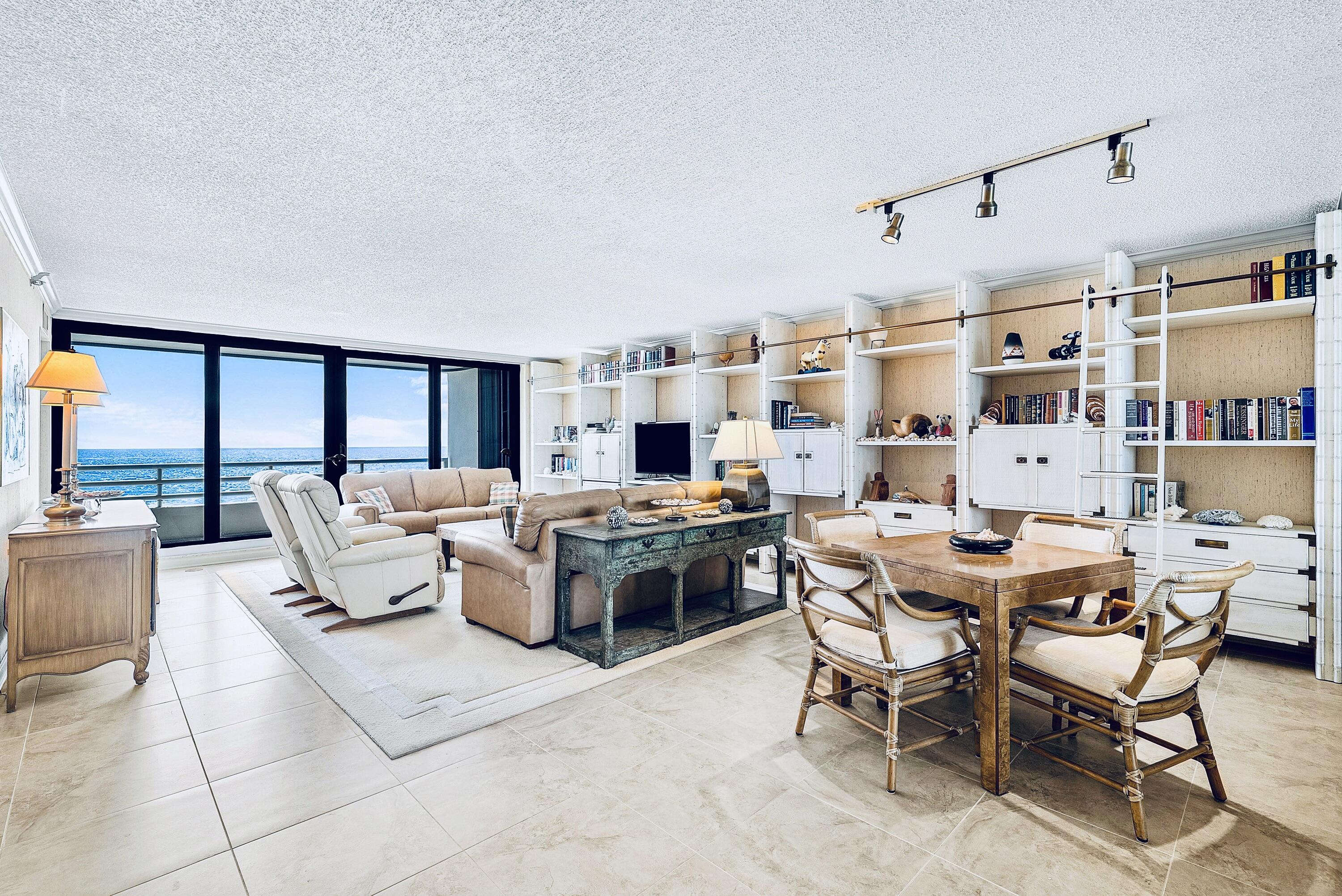 a living room with lots of furniture and a large window