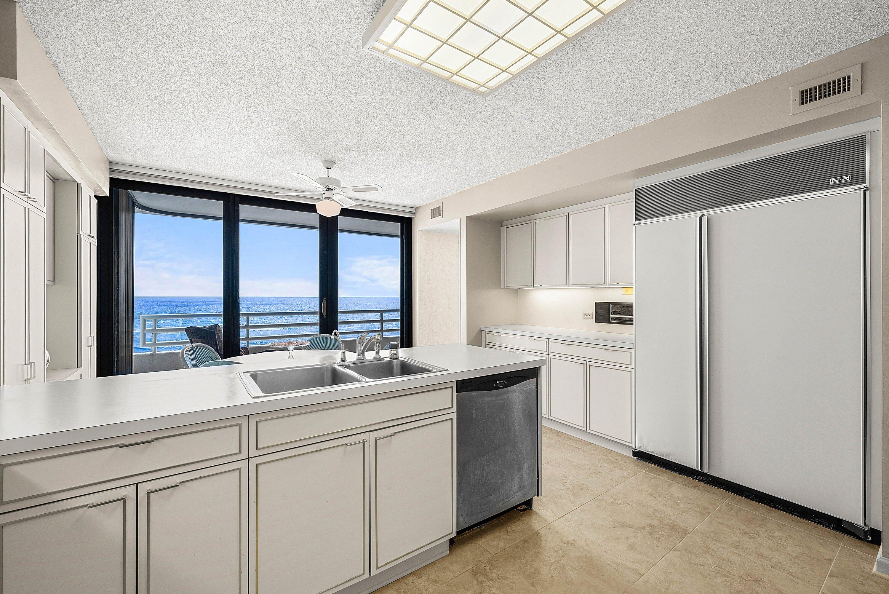 1500 South Ocean Boulevard, Unit 604 Boca Raton, FL 33432 - Photo 20 of 61 a kitchen with sink cabinets and large window