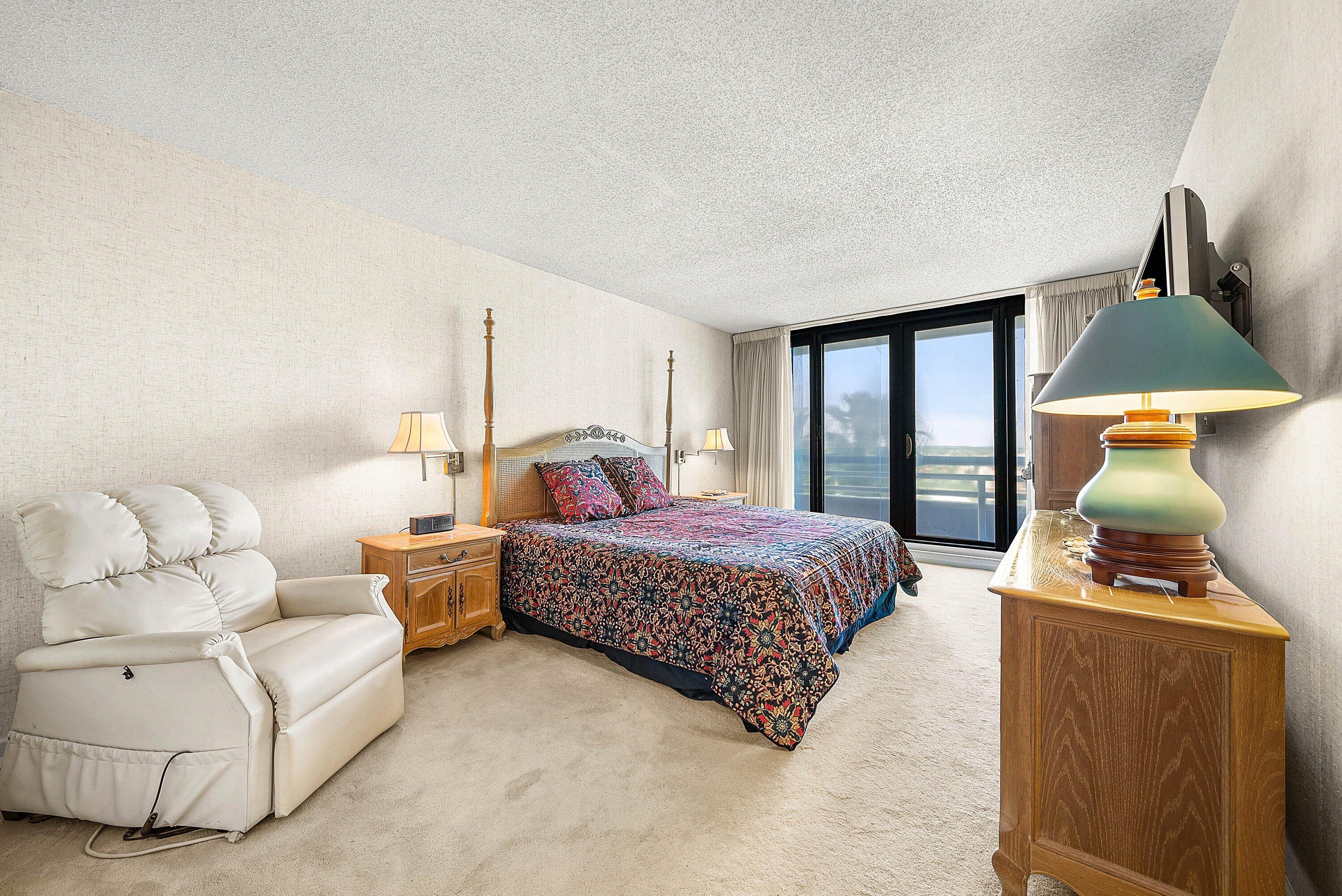 1500 South Ocean Boulevard, Unit 604 Boca Raton, FL 33432 - Photo 22 of 61 a bedroom with a bed and lamp