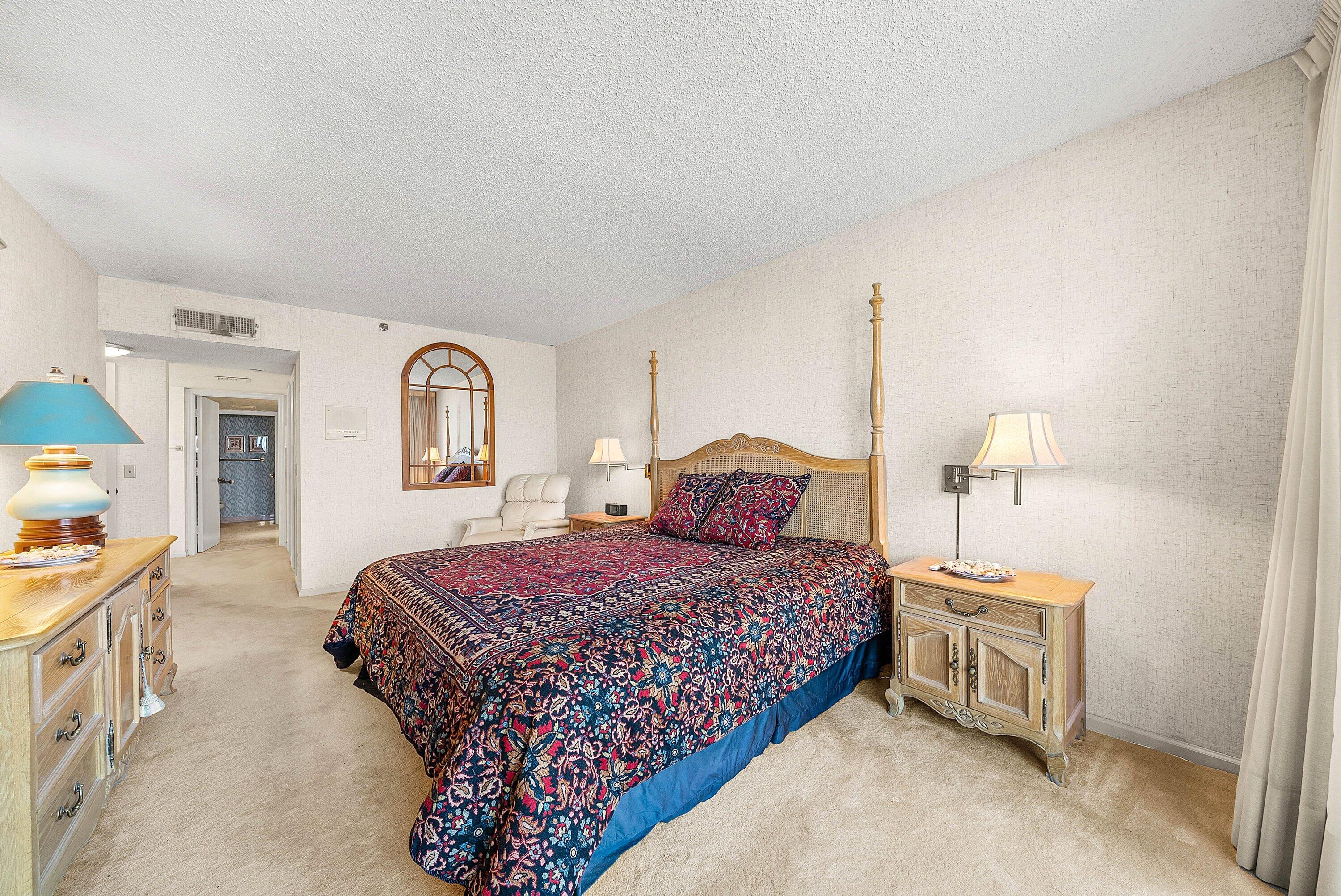 1500 South Ocean Boulevard, Unit 604 Boca Raton, FL 33432 - Photo 23 of 61 a bedroom with a bed and a night stand