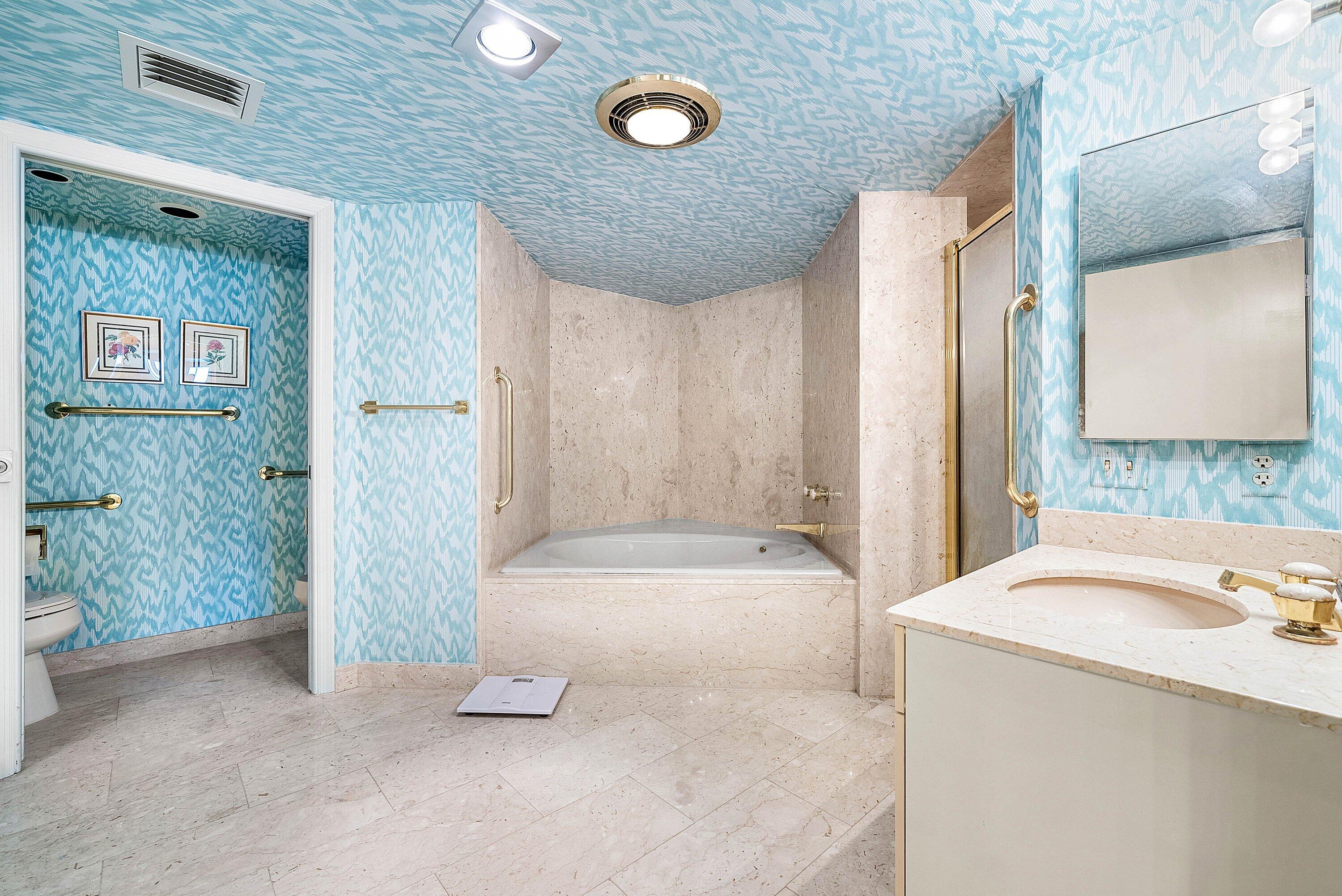 1500 South Ocean Boulevard, Unit 604 Boca Raton, FL 33432 - Photo 25 of 61 a bathroom with a tub a sink and a large mirror