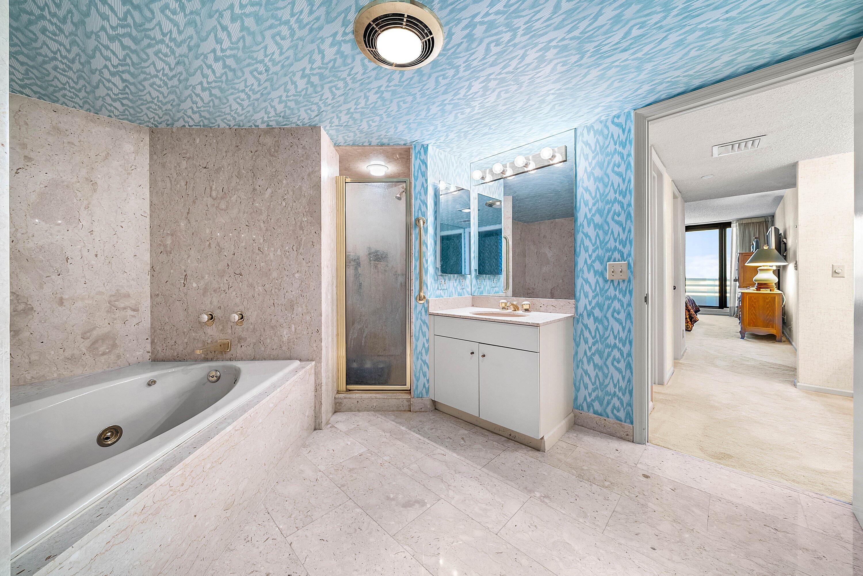 1500 South Ocean Boulevard, Unit 604 Boca Raton, FL 33432 - Photo 26 of 61 a bathroom with a tub a sink a mirror and a shower