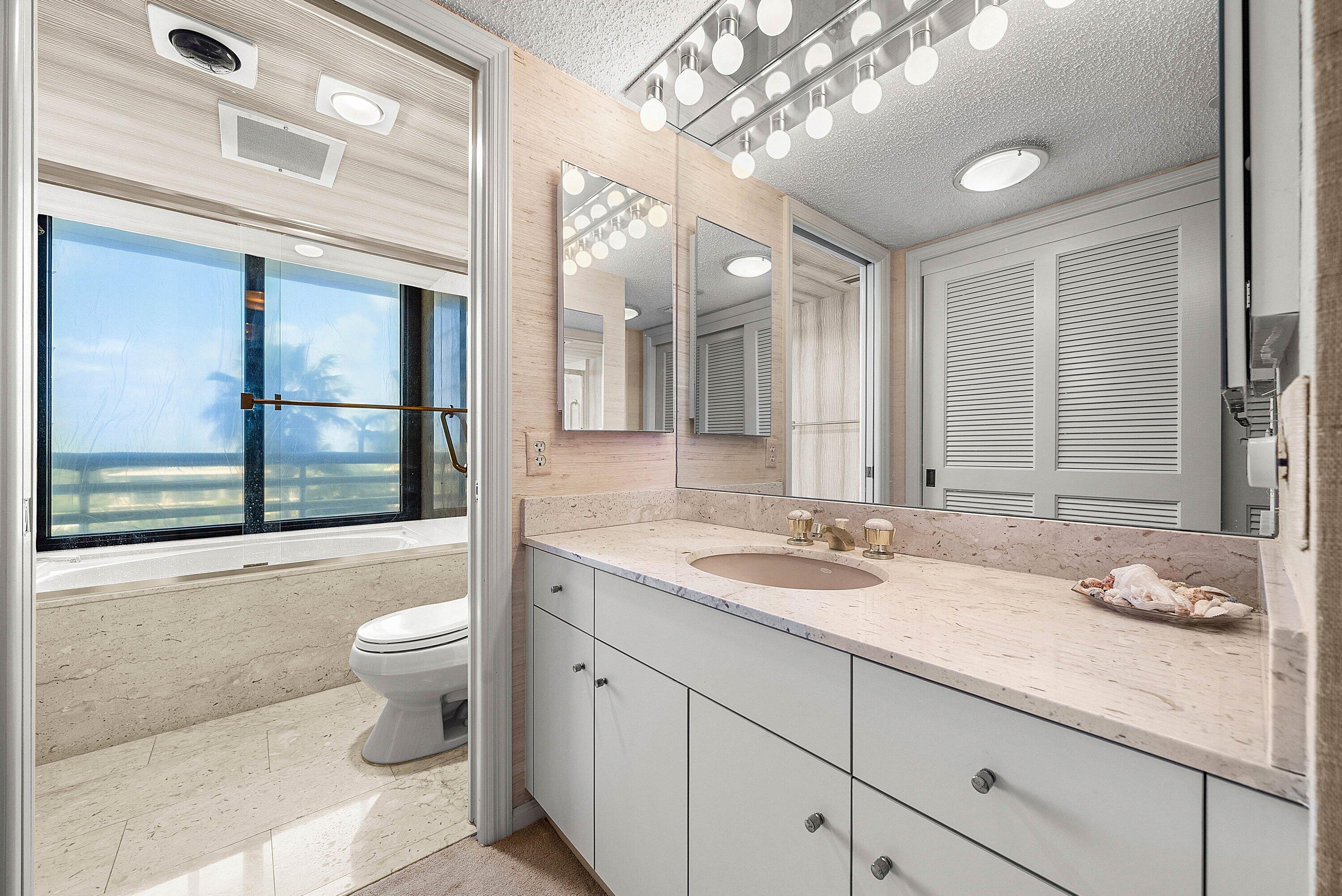 1500 South Ocean Boulevard, Unit 604 Boca Raton, FL 33432 - Photo 29 of 61 a bathroom with a granite countertop sink and a mirror