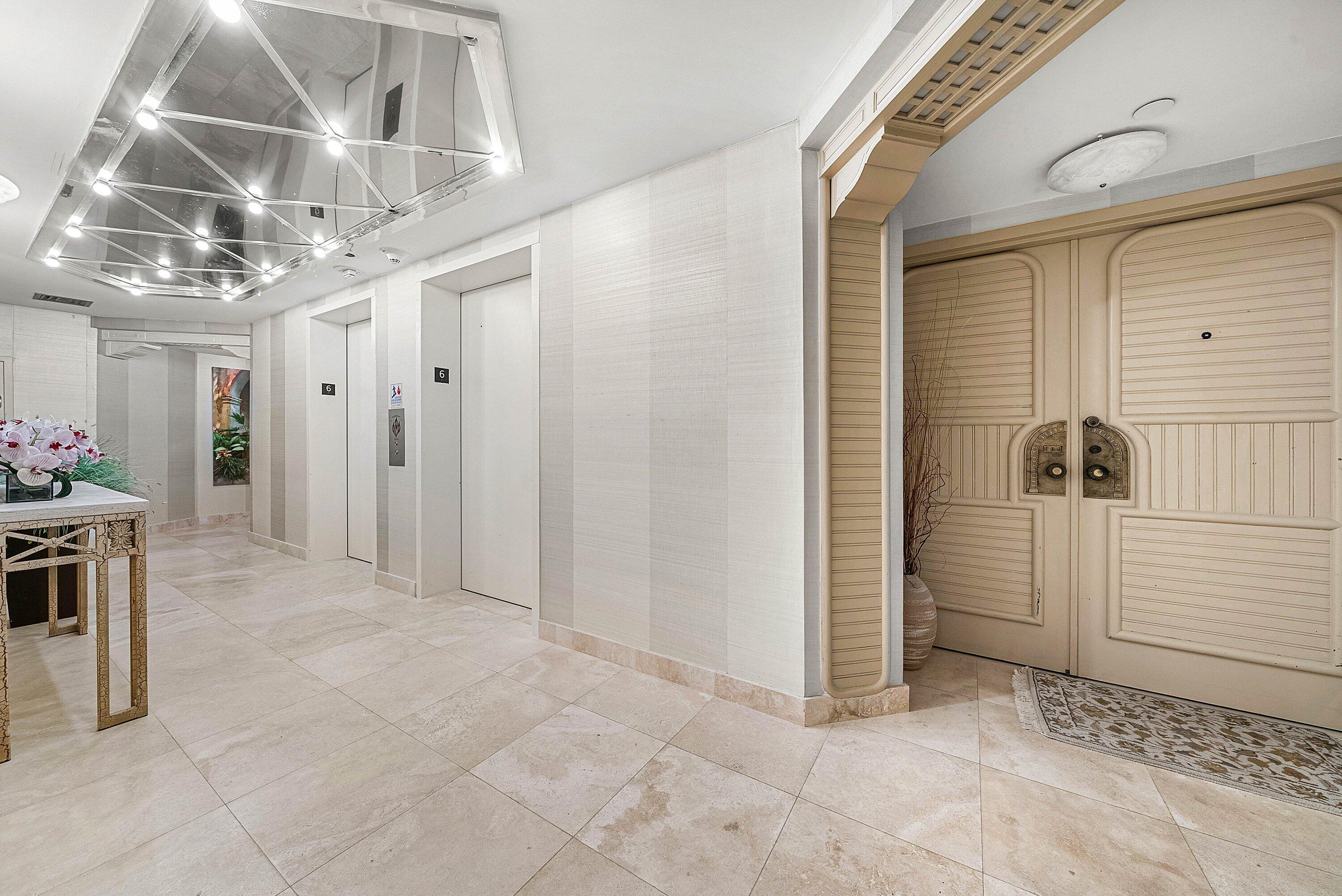1500 South Ocean Boulevard, Unit 604 Boca Raton, FL 33432 - Photo 32 of 61 a view of a hallway with an entryway and chandelier