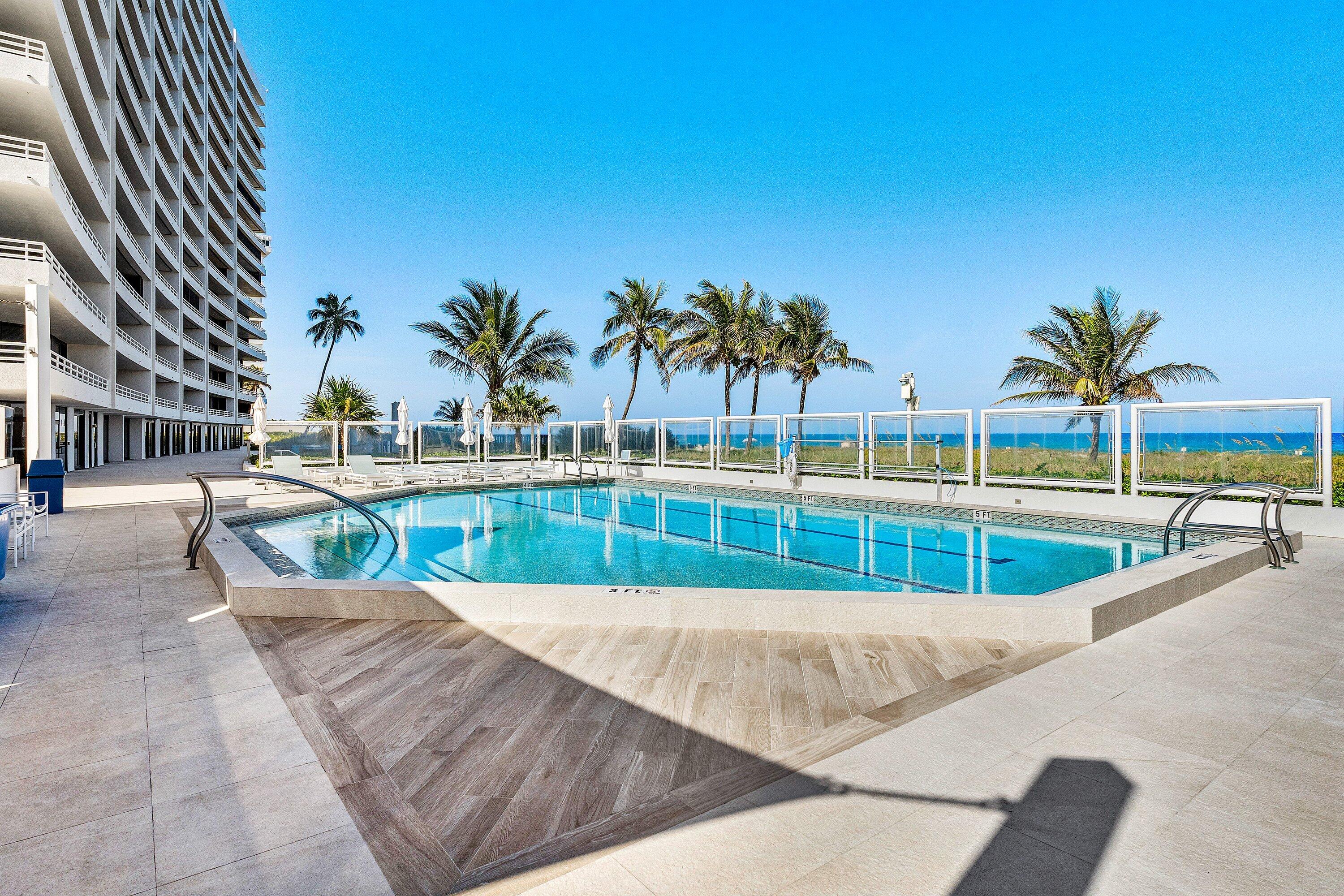 1500 South Ocean Boulevard, Unit 604 Boca Raton, FL 33432 - Photo 40 of 61 a view of swimming pool with a lawn chairs and palm tree