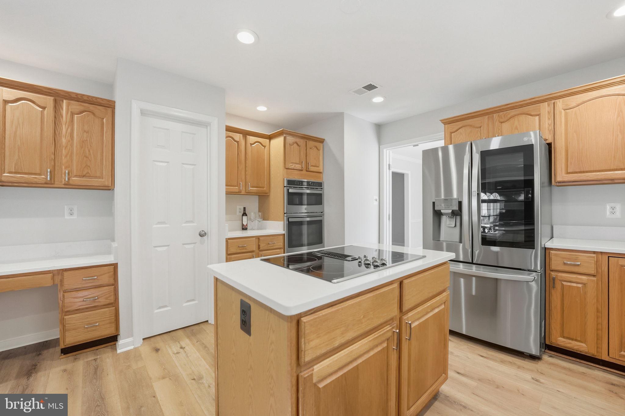 21507 Tithables Circle Broadlands, VA 20148 - Photo 16 of 64 a kitchen that has a sink and a stove in it