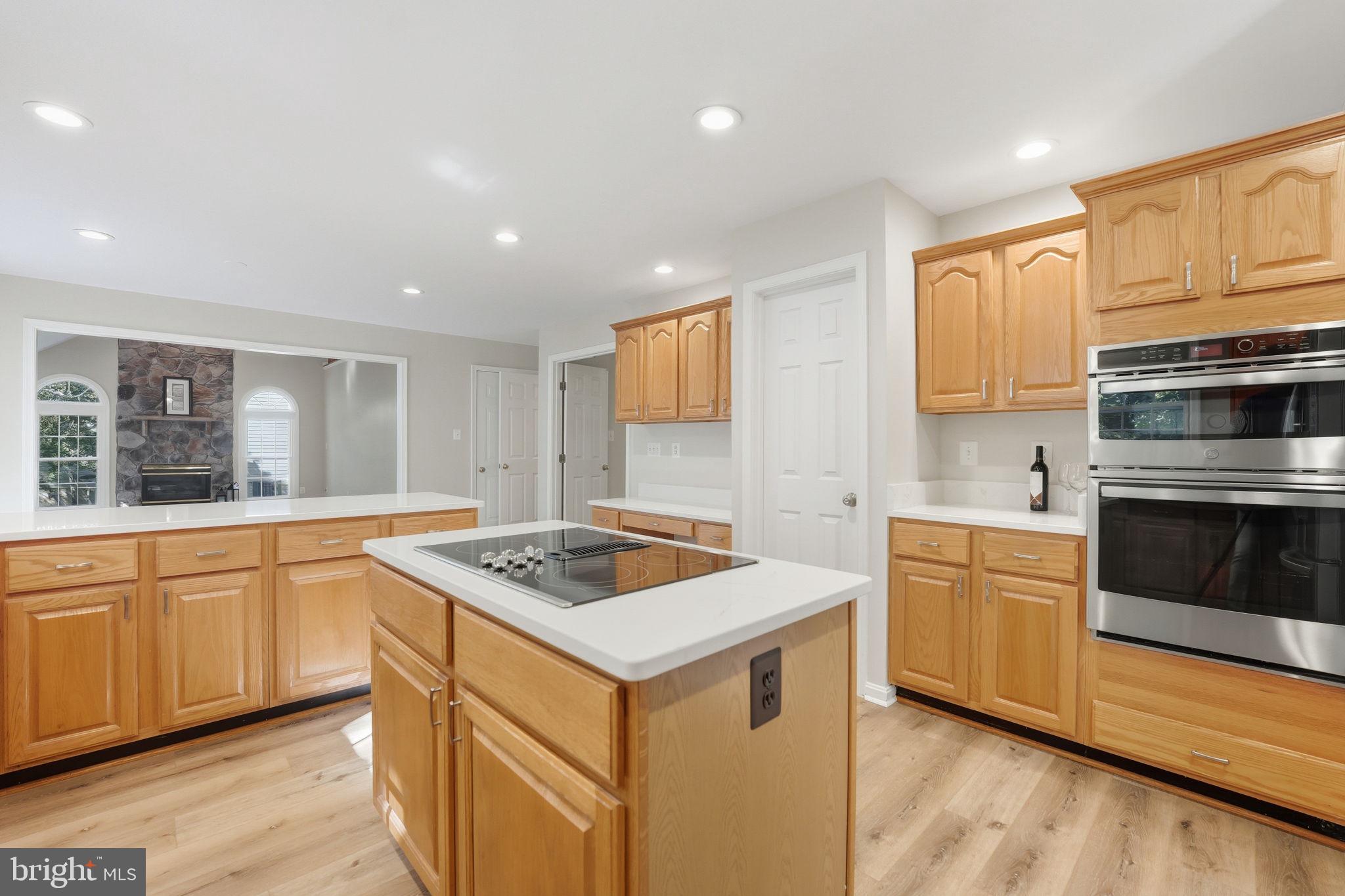 21507 Tithables Circle Broadlands, VA 20148 - Photo 17 of 64 a kitchen that has a sink and a stove in it
