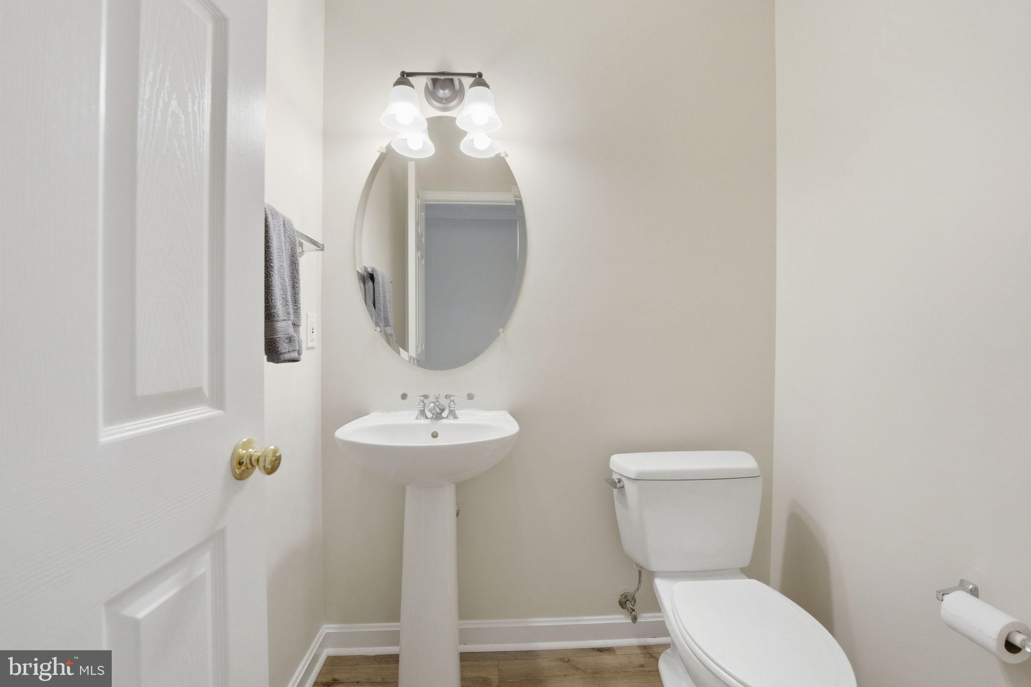 21507 Tithables Circle Broadlands, VA 20148 - Photo 23 of 64 a bathroom with a toilet sink and mirror