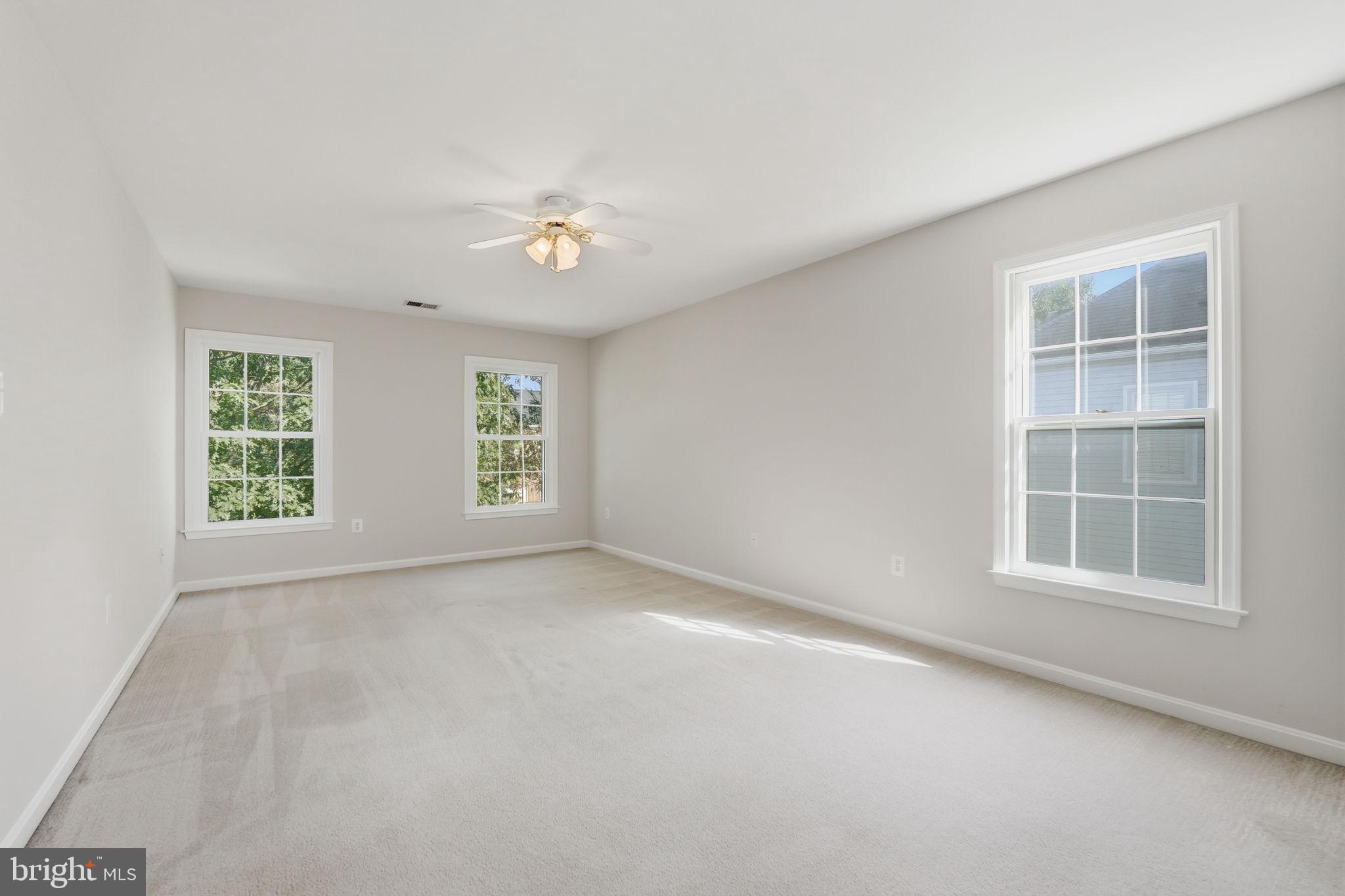 21507 Tithables Circle Broadlands, VA 20148 - Photo 35 of 64 an empty room with windows and entrance