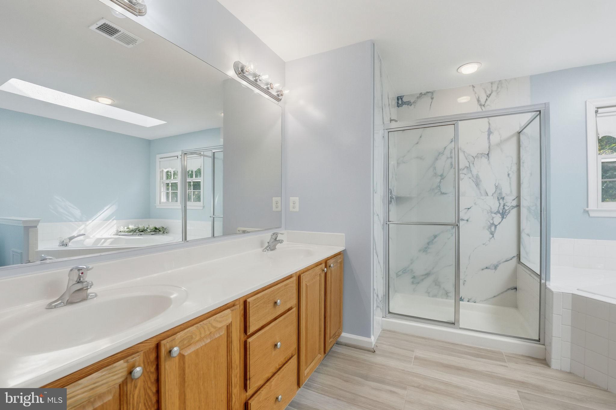 21507 Tithables Circle Broadlands, VA 20148 - Photo 38 of 64 a bathroom with a shower sink and mirror