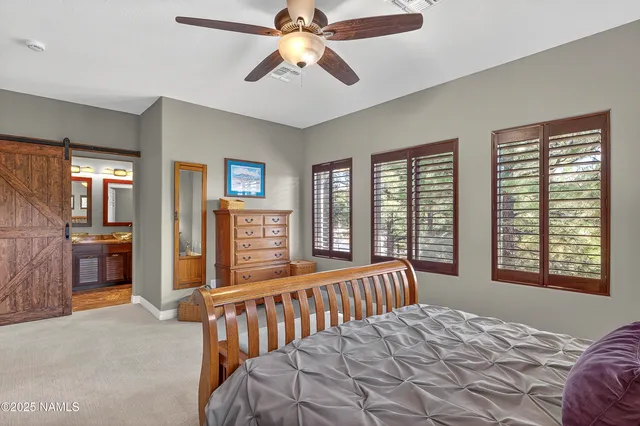 a bedroom with a large bed and a chandelier