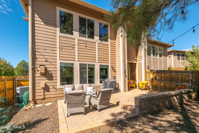 a view of a patio with couches table and chairs and potted plants