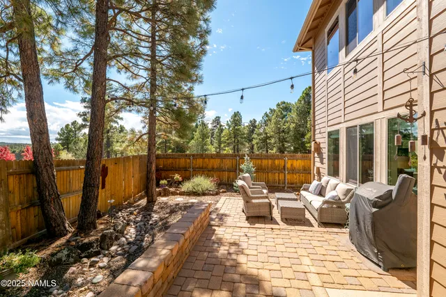 a view of a patio with couches table and chairs and potted plants