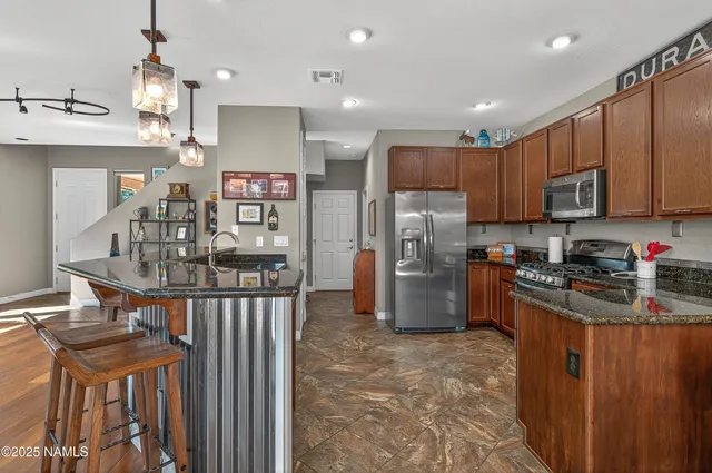 a kitchen with refrigerator and cabinets