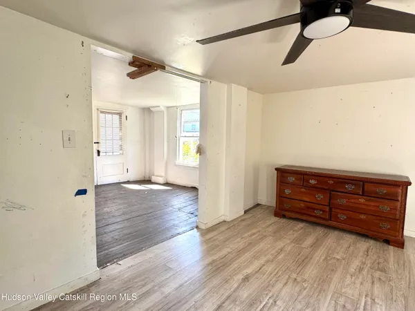 a view of room with window and wooden floor