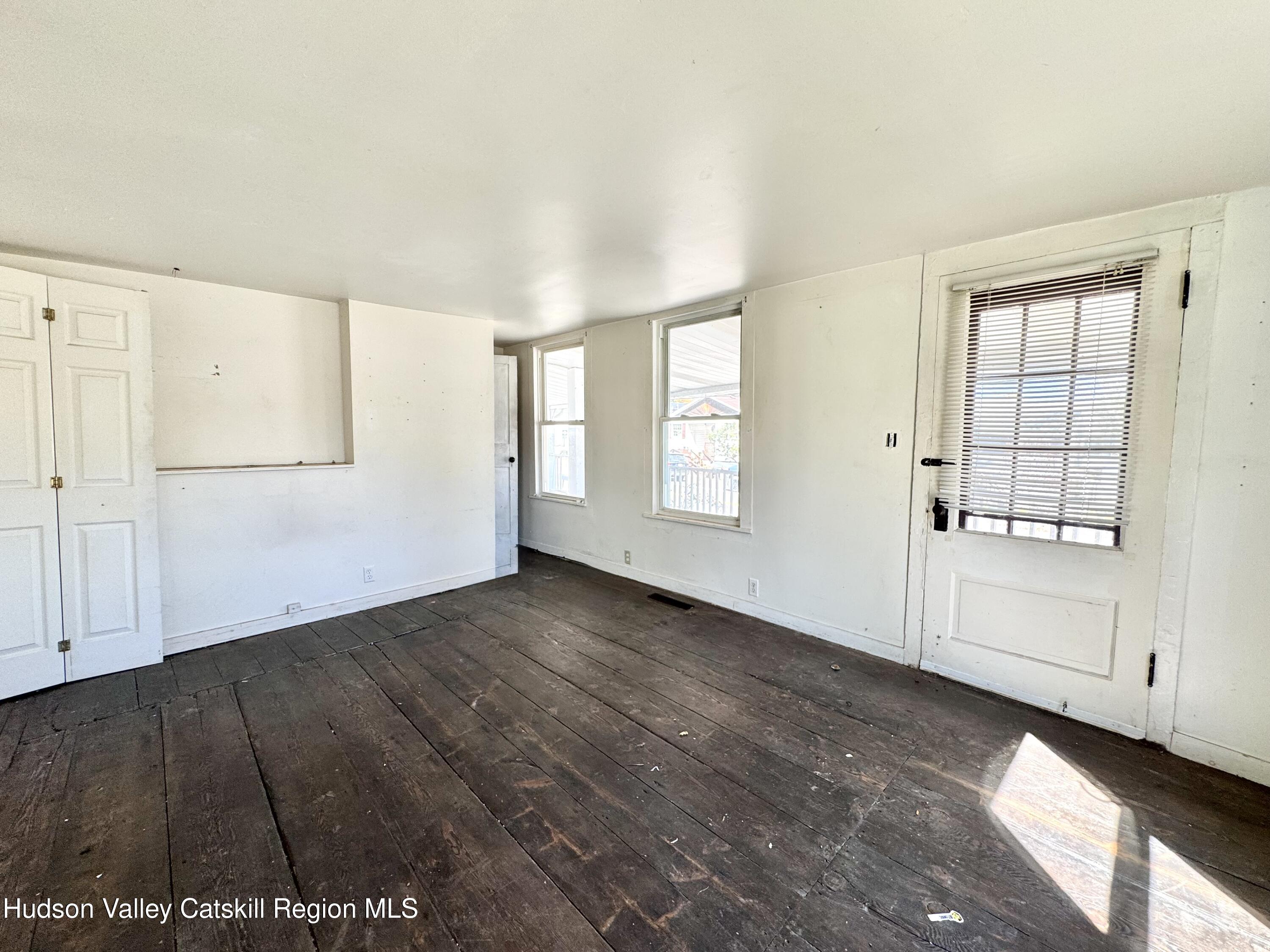 384 Highway 296 Windham, NY 12439 - Photo 13 of 26 an empty room with wooden floor and windows