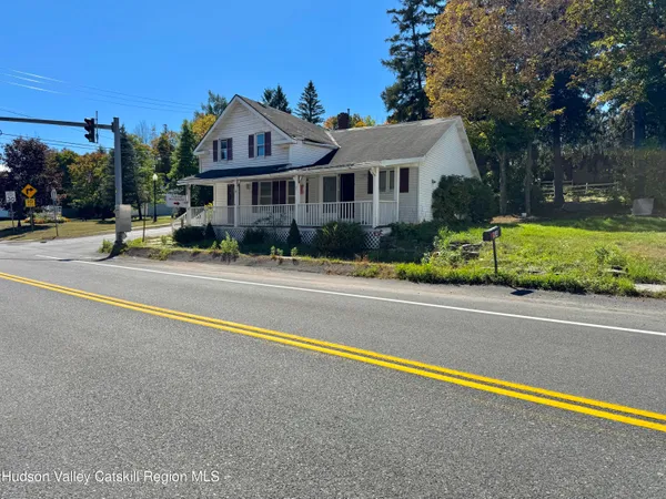 a front view of a house with a yard and table and chairs