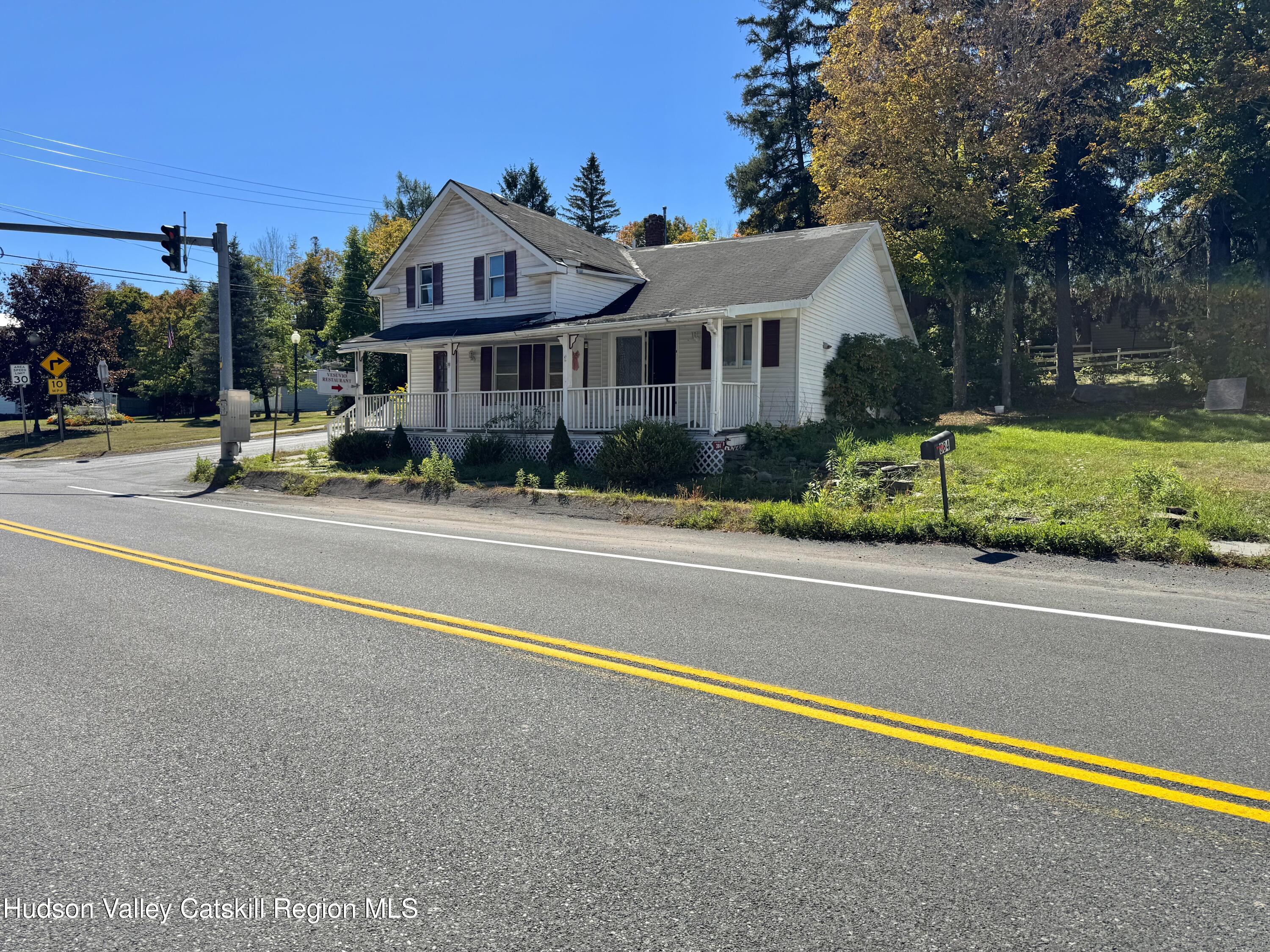 384 Highway 296 Windham, NY 12439 - Photo 2 of 26 a front view of a house with a yard and table and chairs