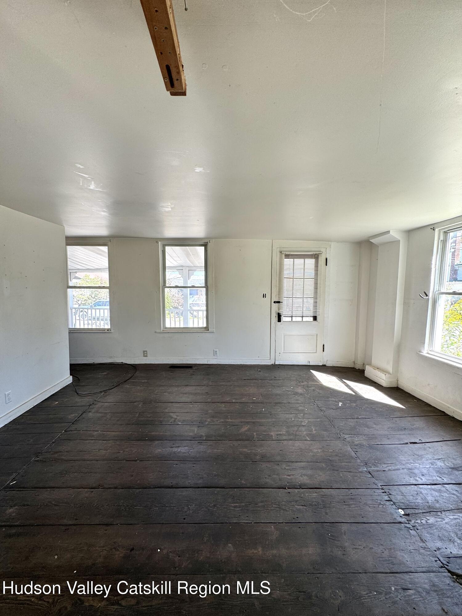384 Highway 296 Windham, NY 12439 - Photo 23 of 26 an empty room with wooden floor and windows