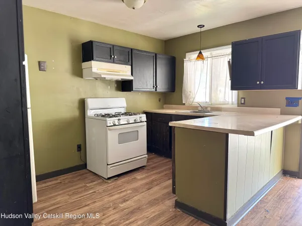 a kitchen with a sink stove and cabinets