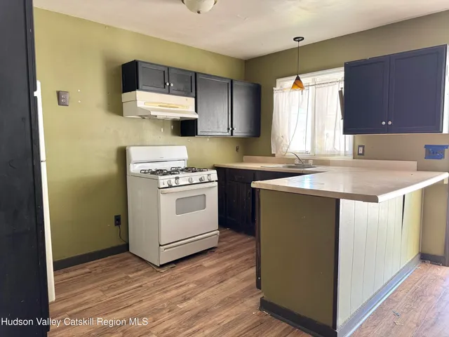 a kitchen with a sink stove and cabinets