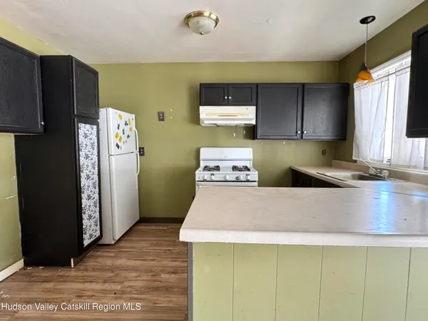 a kitchen with kitchen island a counter top space and a refrigerator