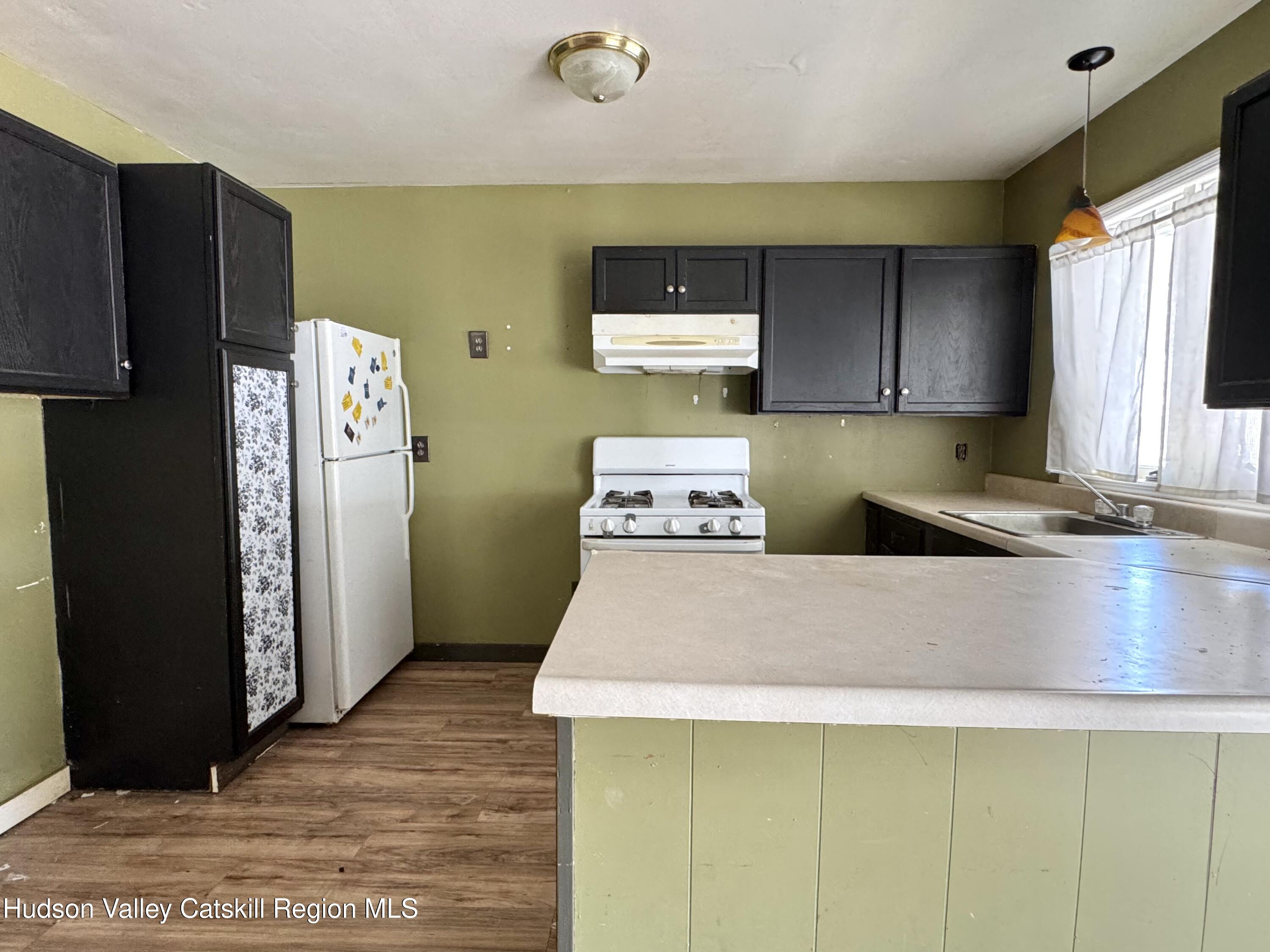 384 Highway 296 Windham, NY 12439 - Photo 5 of 26 a kitchen with kitchen island a counter top space and a refrigerator