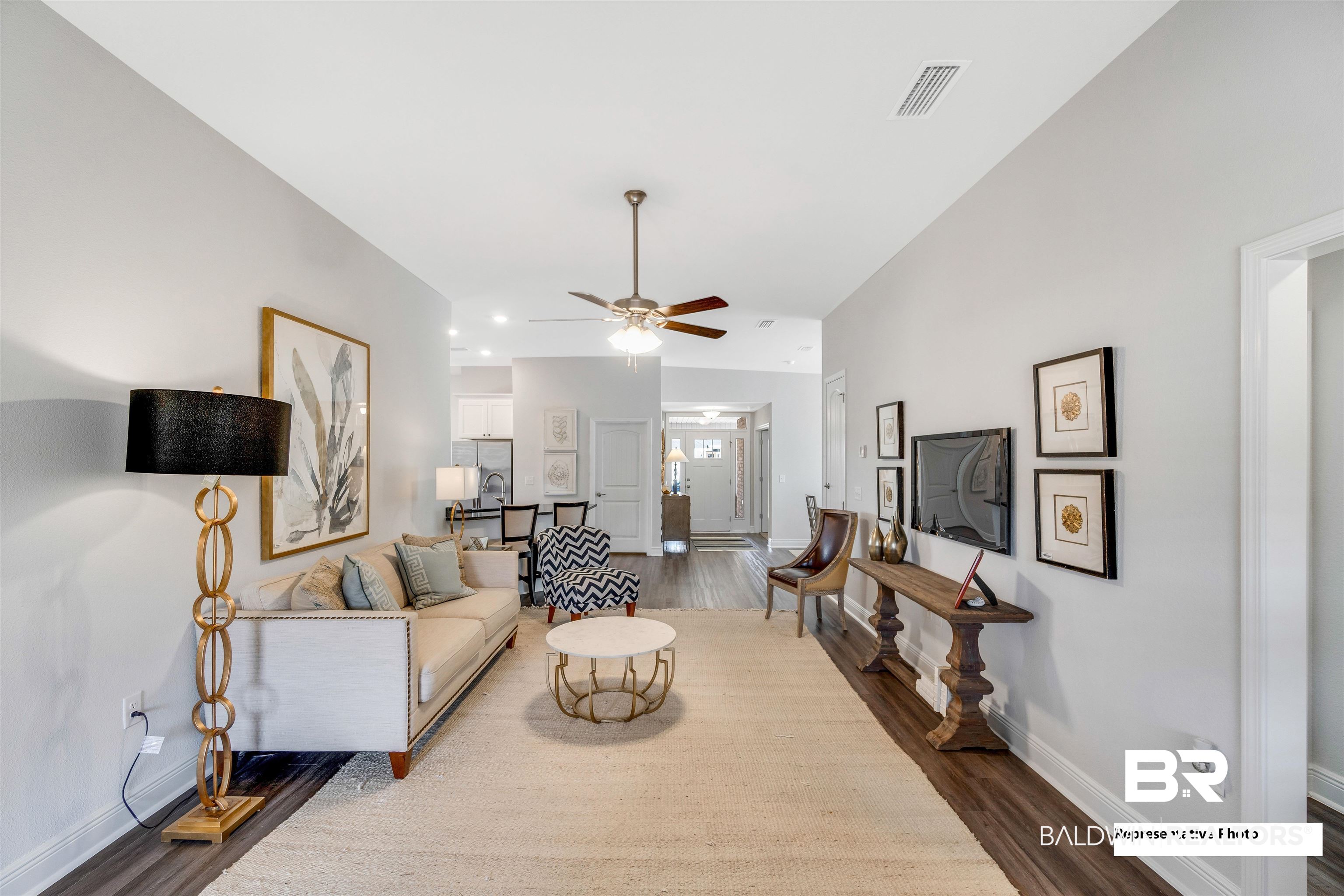 643 Mayflower Drive Foley, AL 36535 - Photo 22 of 34 Living area featuring a ceiling fan, baseboards, visible vents, and wood finished floors