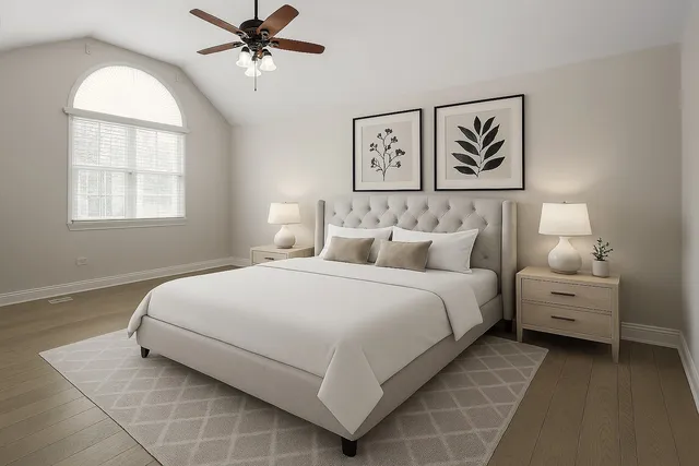 a bedroom with a bed and painting on the wall