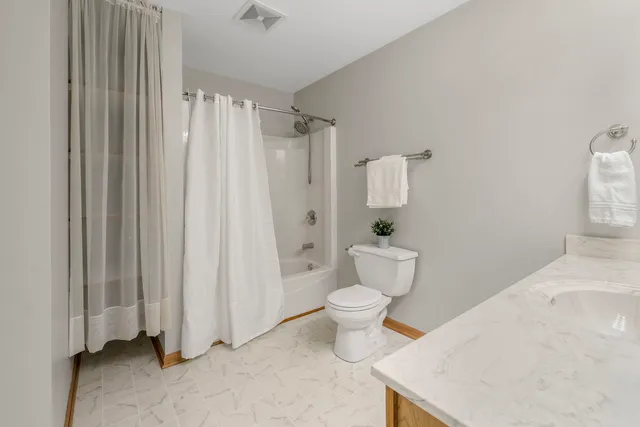 a white toilet sitting next to a bathroom sink