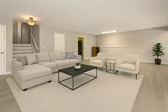 a living room with furniture and a lamp