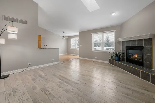a view of an empty room with a fireplace and a window