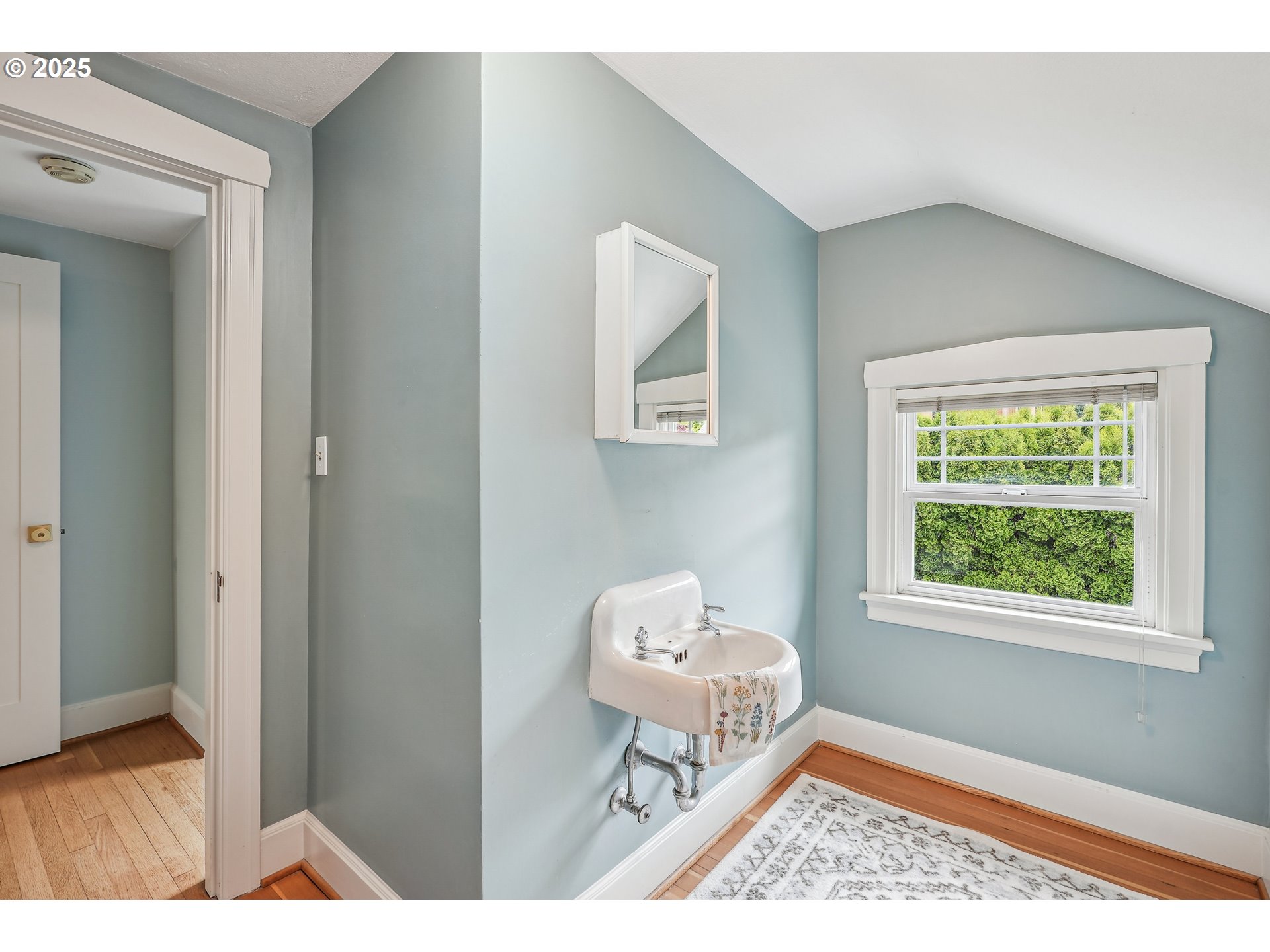 4324 Southeast 28th Avenue Portland, OR 97202 - Photo 24 of 42 a living room with a baby crib furniture and a window