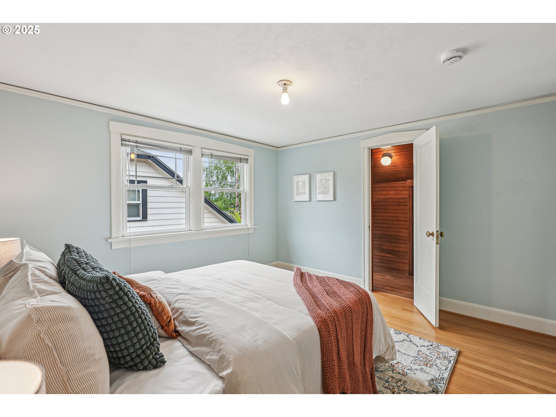4324 Southeast 28th Avenue Portland, OR 97202 - Photo 25 of 42 a bedroom with a bed and a window
