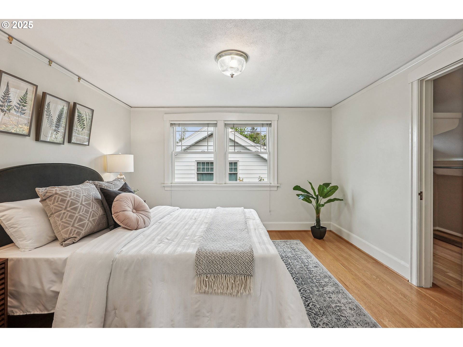 4324 Southeast 28th Avenue Portland, OR 97202 - Photo 28 of 42 a bedroom with a large bed and a window