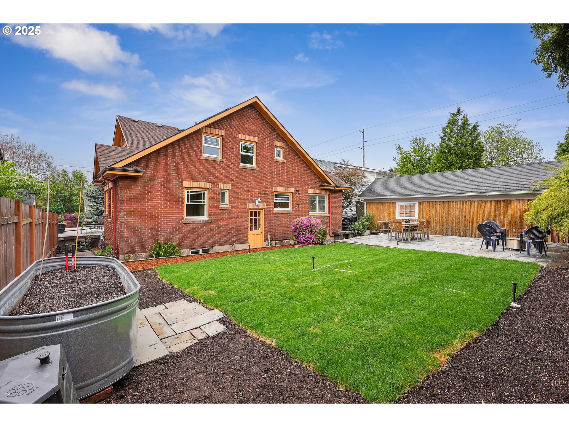 4324 Southeast 28th Avenue Portland, OR 97202 - Photo 40 of 42 a backyard of a house with table and chairs plants and large tree