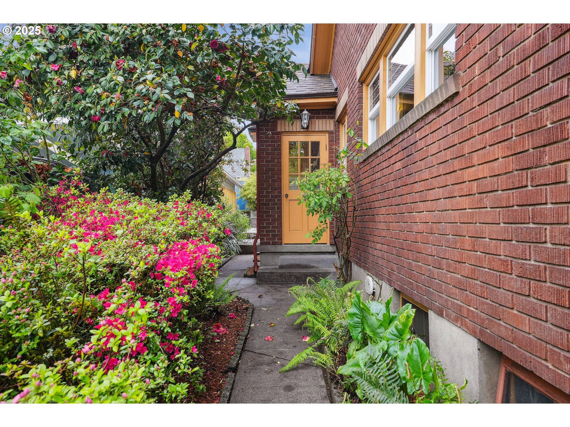 4324 Southeast 28th Avenue Portland, OR 97202 - Photo 42 of 42 a view of a house with a lot of flower plants