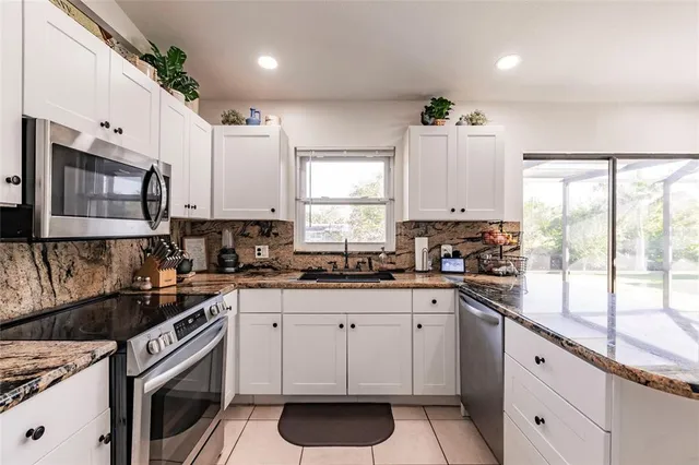 a kitchen with stainless steel appliances a refrigerator and a stove
