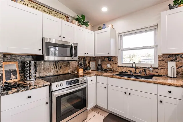 a kitchen with cabinets and stainless steel appliances