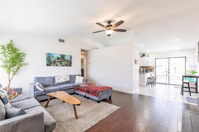 a living room with furniture and wooden floor