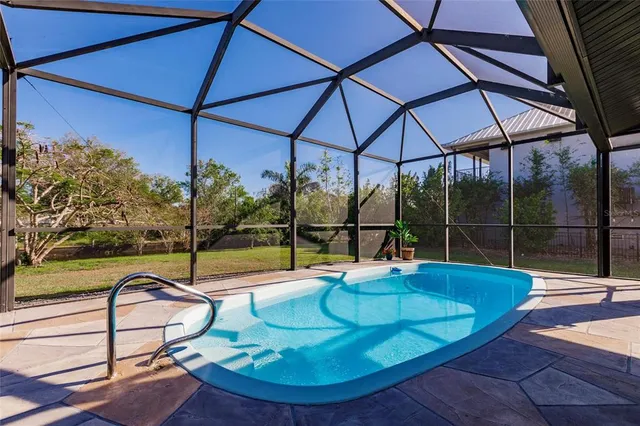 a backyard of a house with table and chairs