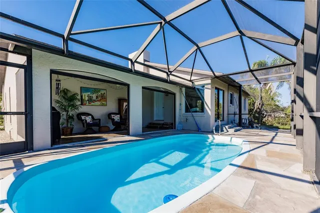 a view of house with backyard and sitting area