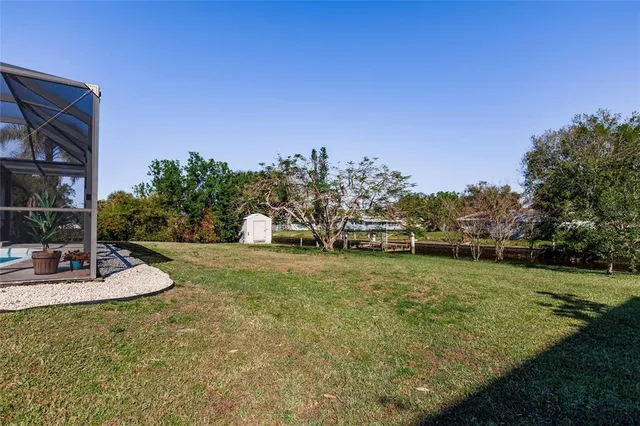 an aerial view of a house with swimming pool and lake view