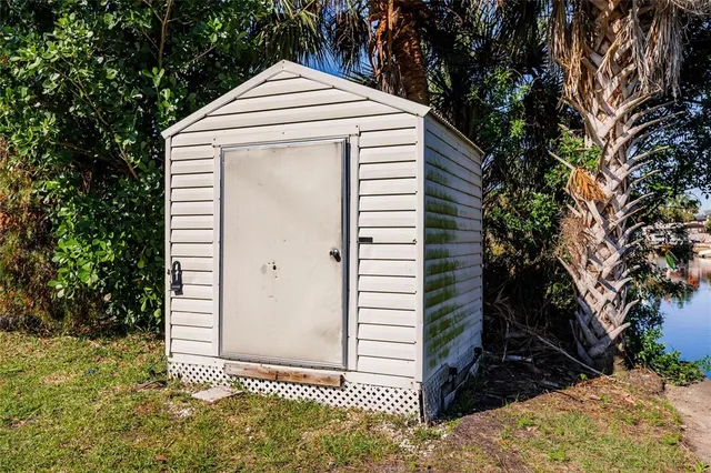 a aerial view of a city with lots of residential buildings ocean and mountain view in back