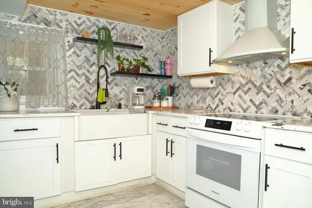 a kitchen with white cabinets and white appliances